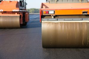 Steamroller Leveling Asphalt Before Sealing